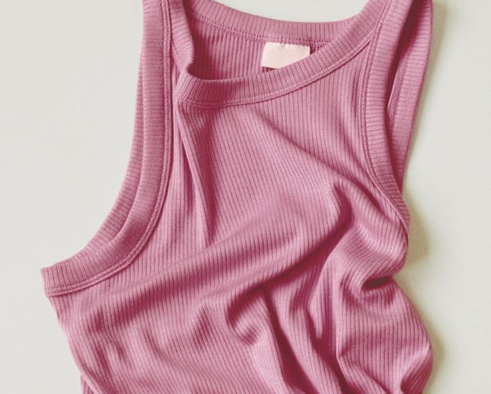 Soft pink ribbed tank top made with modal material, showcasing the natural drape and comfort of TENCEL™ Modal fibers